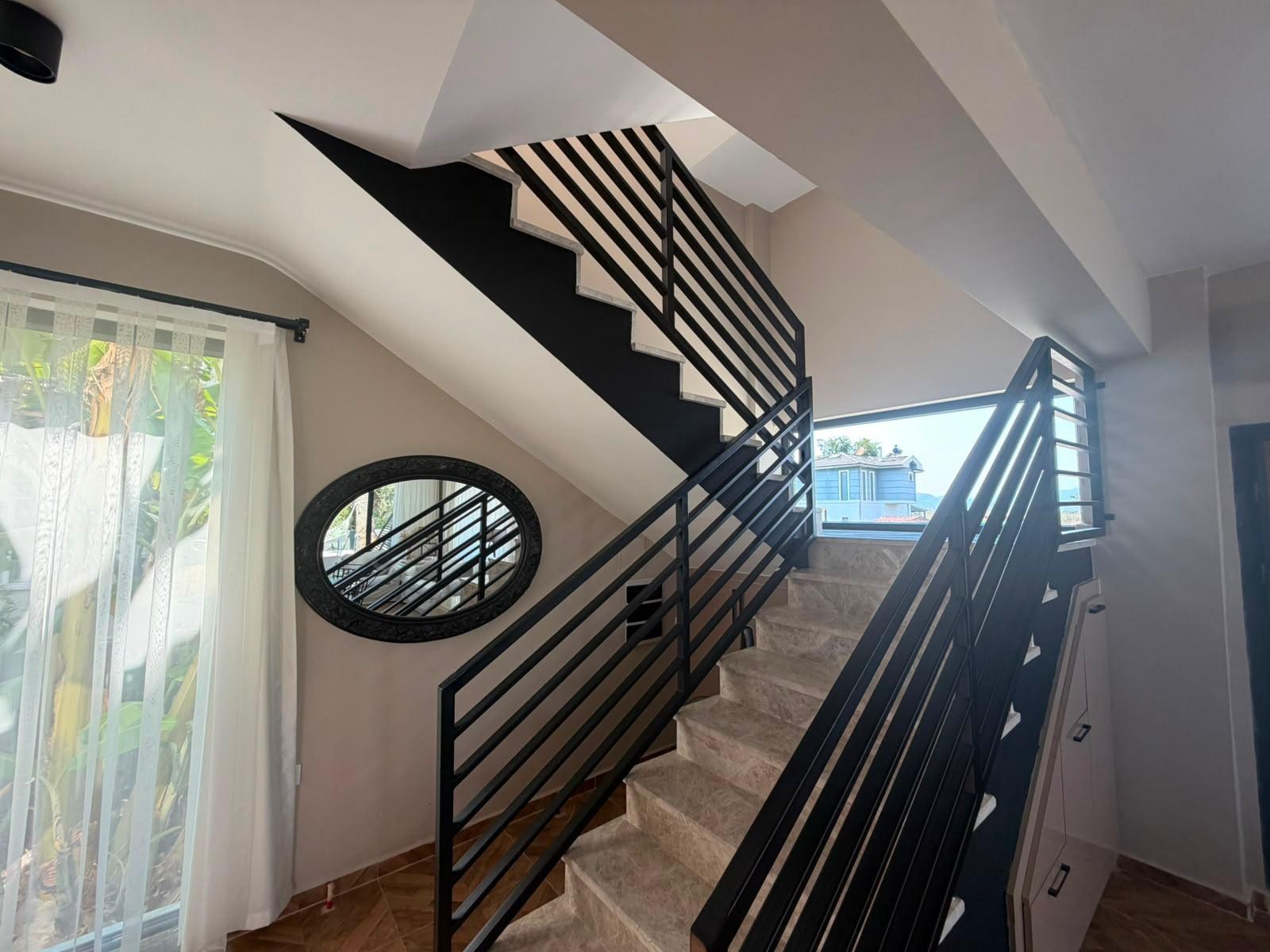 Staircase detail with round mirror