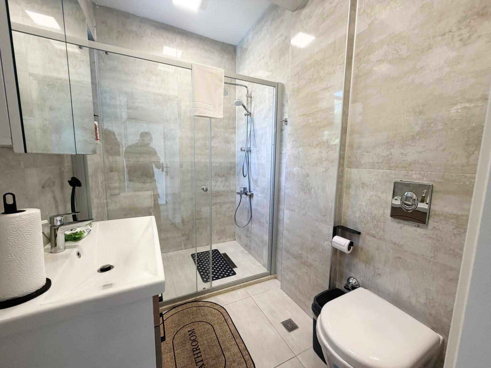 Bathroom 1 with glass-walled shower