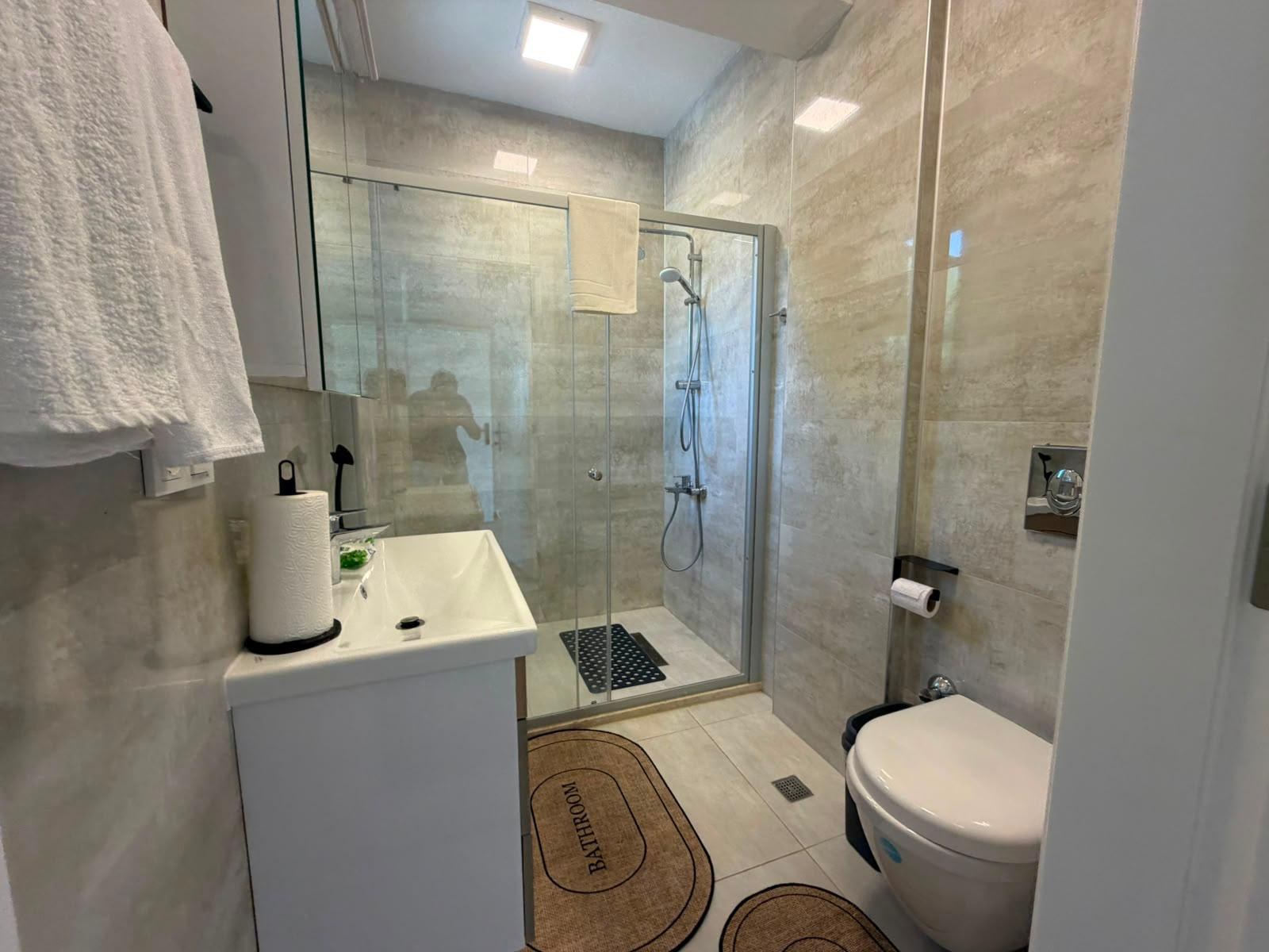 Bathroom 2 with glass shower and vanity