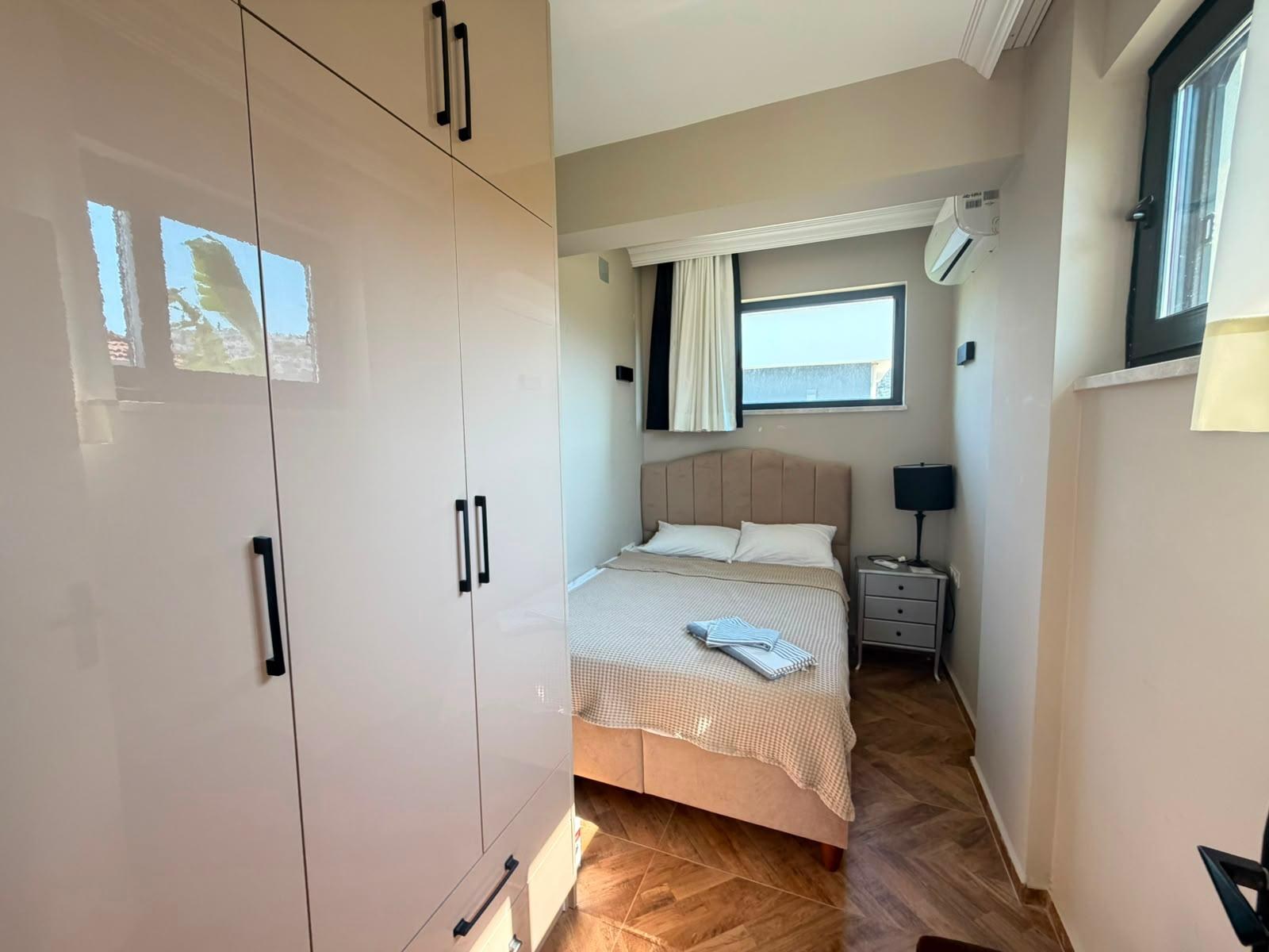 Bedroom 1 with wardrobe and garden-view window