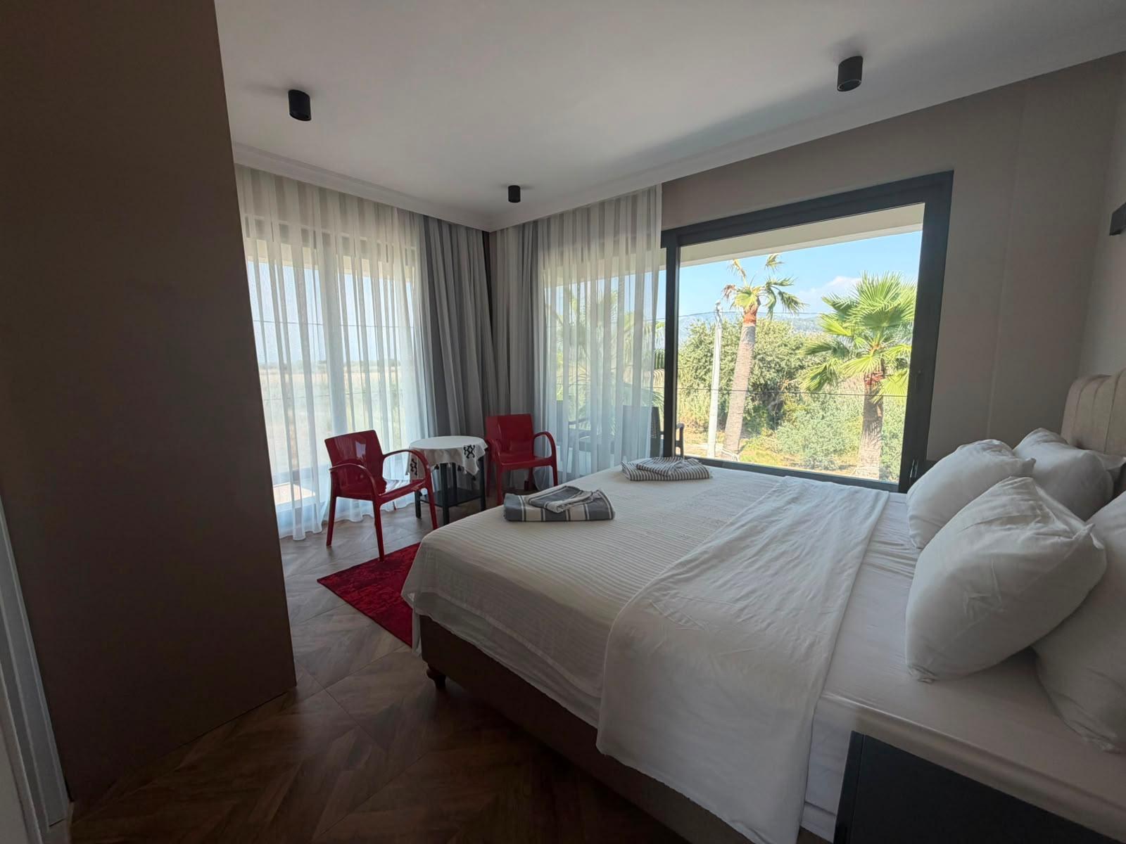 Bedroom 2 with seating area and large window