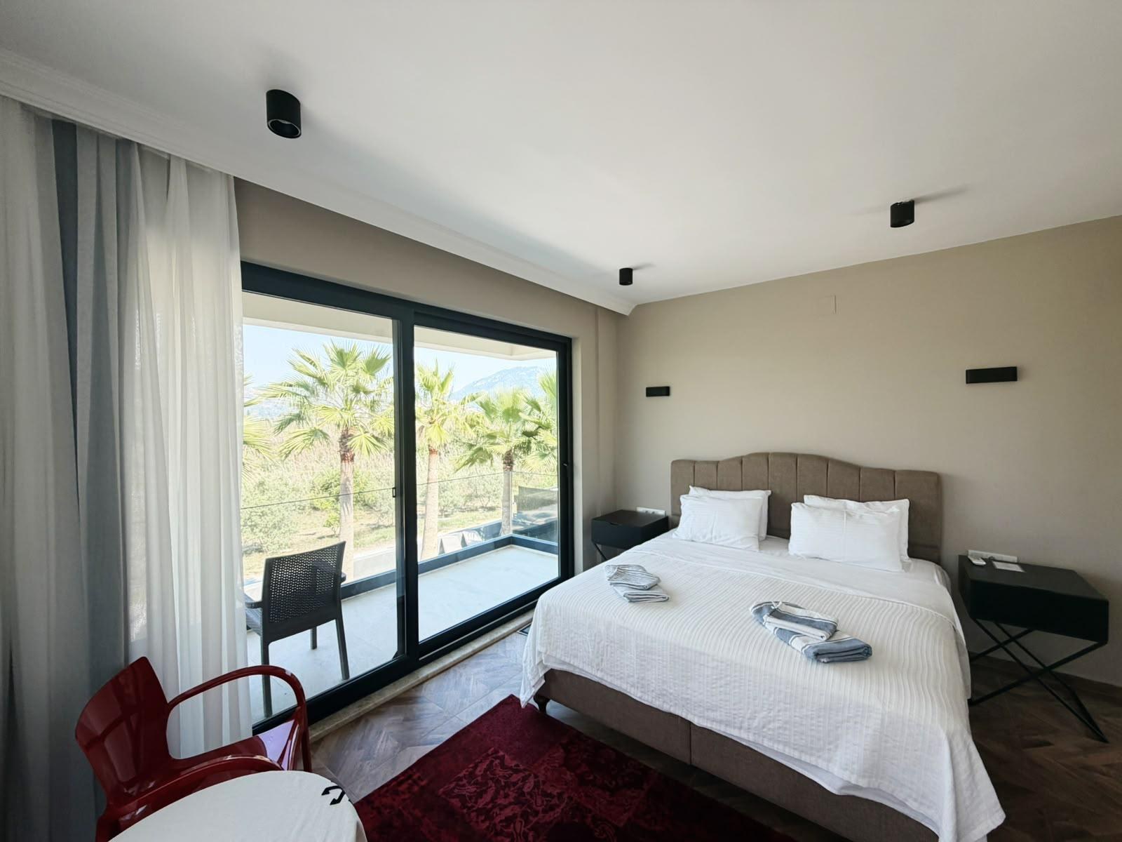 Bedroom 2 with balcony doors open to the garden