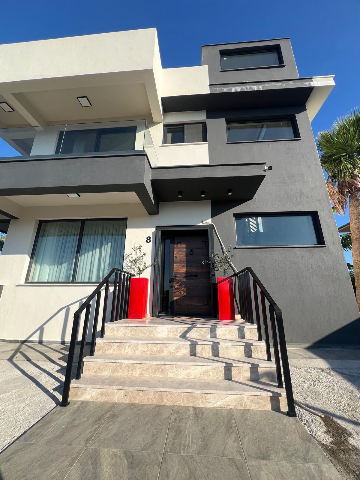 Villa entrance with red planters