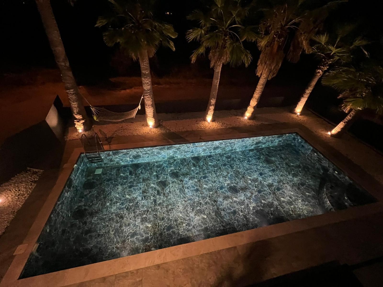 Private pool lit at night, close view