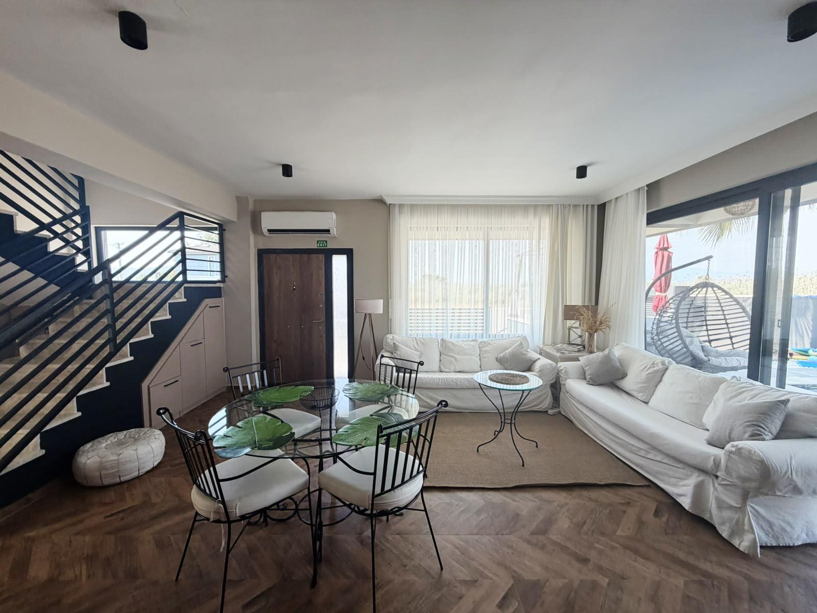 Living and dining area with staircase